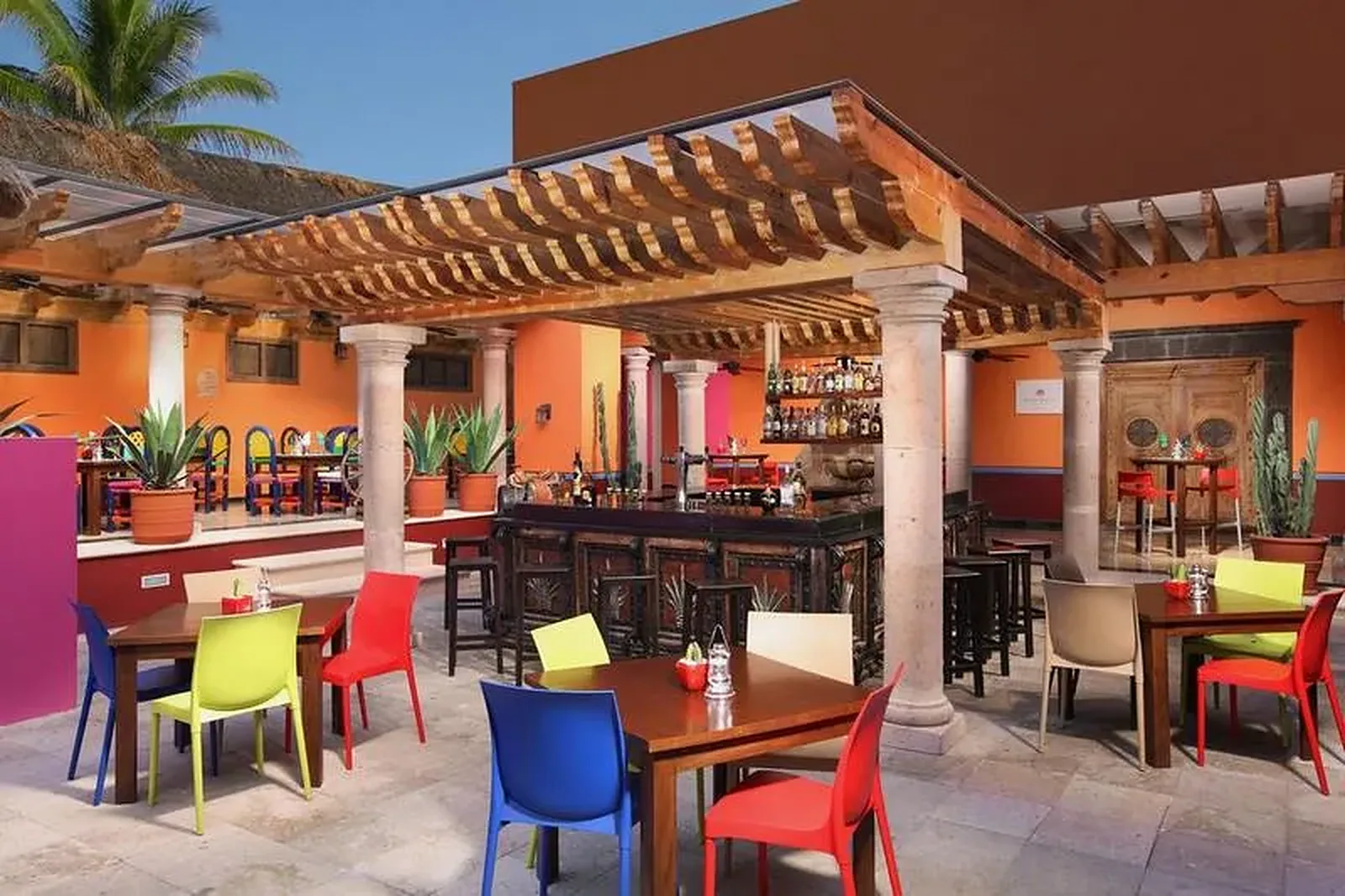 Šarena terasa bara na otvorenom sa živopisnim sedištima · Grand Oasis Cancun Hotel